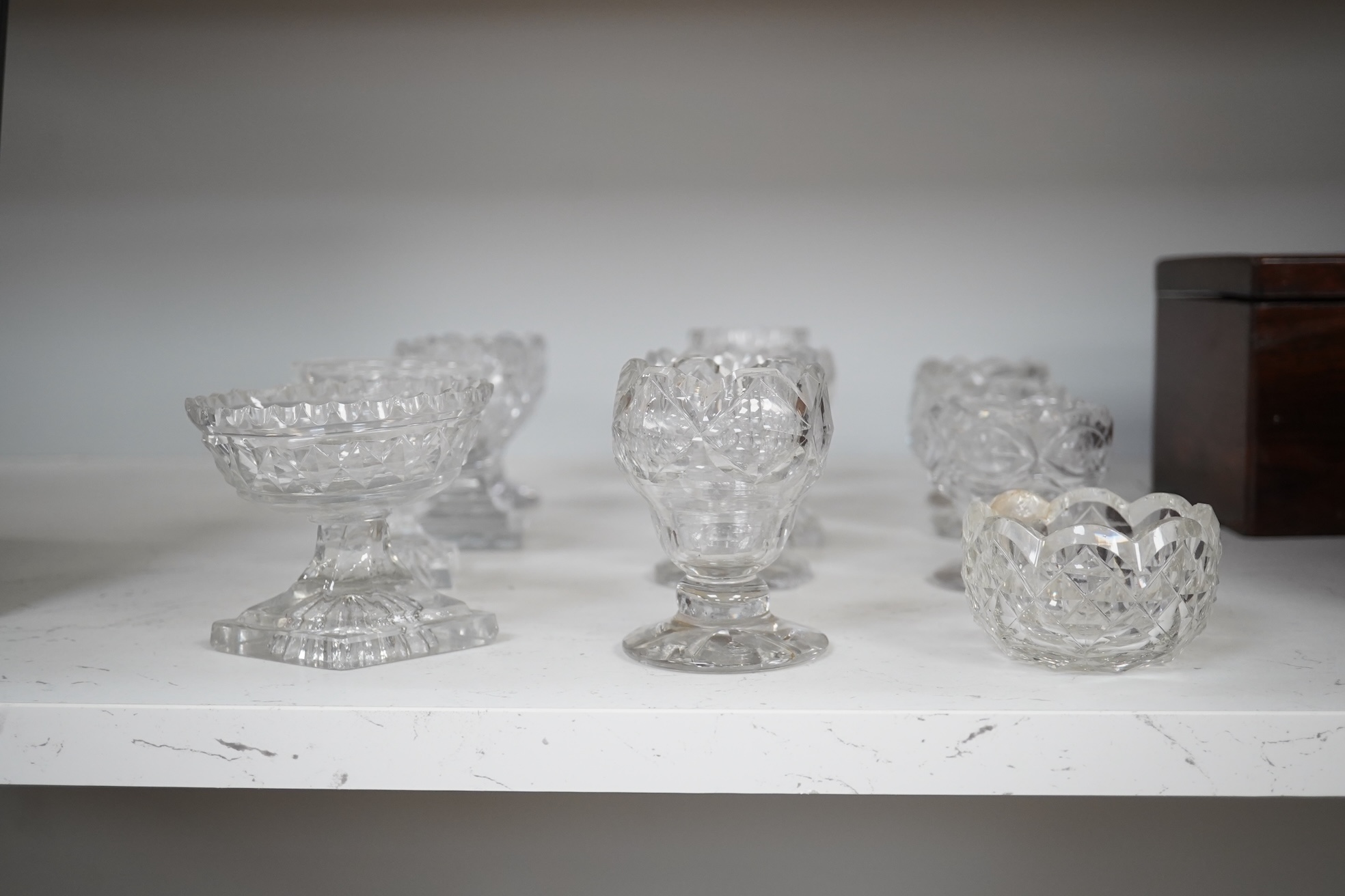 A group of twelve Georgian cut glass salts, tallest 9cm. Condition - fair to good, some chipping